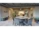 Covered patio with a dining table and comfortable seating, perfect for outdoor living and entertaining at 18175 W Highland Ave, Goodyear, AZ 85395