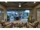 Twilight view of covered patio, outdoor kitchen, pool, putting green, and desert landscaping at 18175 W Highland Ave, Goodyear, AZ 85395