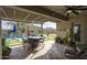 Covered patio includes seating, outdoor kitchen, pool, putting green, and beautiful desert landscaping at 18175 W Highland Ave, Goodyear, AZ 85395