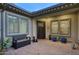 Private outdoor space featuring a brick patio, outdoor seating, and a secure entrance at 18175 W Highland Ave, Goodyear, AZ 85395