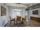 Elegant dining room features a modern chandelier, wood floors, and shutters for a sophisticated ambiance at 18175 W Highland Ave, Goodyear, AZ 85395