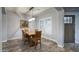 Cozy dining room with hardwood floors, a farmhouse-style table, and natural light from shuttered windows at 18175 W Highland Ave, Goodyear, AZ 85395