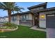 Home with a brick walkway and manicured lawn leading to a secure metal screen door at 18175 W Highland Ave, Goodyear, AZ 85395