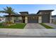 Charming single Gathering home showcasing desert landscaping, manicured lawn, and a spacious two-car garage at 18175 W Highland Ave, Goodyear, AZ 85395