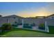 Serene backyard with raised garden beds, a manicured lawn, and mature landscaping at 18175 W Highland Ave, Goodyear, AZ 85395
