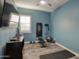 Home gym featuring light blue walls, wood-look tile flooring, and workout equipment at 18175 W Highland Ave, Goodyear, AZ 85395