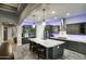 Gourmet kitchen with granite countertops, a modern hood, stainless steel appliances, and plenty of storage at 18175 W Highland Ave, Goodyear, AZ 85395
