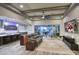 Spacious living room with wood beam ceiling, a ceiling fan, and sliding glass doors to the backyard at 18175 W Highland Ave, Goodyear, AZ 85395