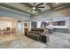 Open concept layout with wood beam ceiling, a ceiling fan, living room, dining room, and a modern kitchen at 18175 W Highland Ave, Goodyear, AZ 85395