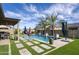 Beautiful backyard pool with waterfalls, lush greenery, and a covered patio perfect for outdoor entertaining and relaxation at 18175 W Highland Ave, Goodyear, AZ 85395