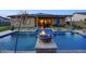 Stunning pool featuring a fire bowl and seamless transition to the covered outdoor living space at 18175 W Highland Ave, Goodyear, AZ 85395