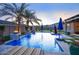 Stunning pool featuring shimmering water, fire bowls, and palm trees at dusk creates an inviting outdoor oasis at 18175 W Highland Ave, Goodyear, AZ 85395