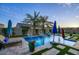 Backyard pool with water feature, lush landscaping, and comfortable lounge chairs offers an ideal outdoor living experience at 18175 W Highland Ave, Goodyear, AZ 85395