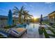 Luxury backyard pool with waterfalls, fire bowls, lounge chairs, and verdant landscaping offers an exquisite outdoor retreat at 18175 W Highland Ave, Goodyear, AZ 85395