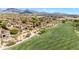 Aerial view of upscale homes, a golf course, and desert landscaping in a private community at 19550 N Grayhawk Dr # 1117, Scottsdale, AZ 85255