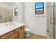 Bathroom with a single sink vanity, toilet, and a glass enclosed shower at 19550 N Grayhawk Dr # 1117, Scottsdale, AZ 85255