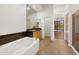 Luxurious bathroom with soaking tub, large vanity with granite countertop, and a walk-in shower at 19550 N Grayhawk Dr # 1117, Scottsdale, AZ 85255