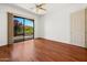 Bedroom with hardwood floors and sliding glass door offering a view of lush outdoor scenery at 19550 N Grayhawk Dr # 1117, Scottsdale, AZ 85255