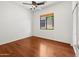 Bedroom featuring hardwood floors, natural light from the window, and a ceiling fan at 19550 N Grayhawk Dr # 1117, Scottsdale, AZ 85255