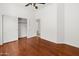Bedroom featuring hardwood floors, an open closet with sliding doors, and white walls at 19550 N Grayhawk Dr # 1117, Scottsdale, AZ 85255