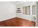 Bright bedroom featuring hardwood floors, floating shelves, and natural light from the window at 19550 N Grayhawk Dr # 1117, Scottsdale, AZ 85255