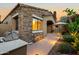 Charming home exterior with brick accents, barbecue, and desert landscaping at 19550 N Grayhawk Dr # 1117, Scottsdale, AZ 85255