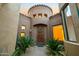 Inviting front entrance with a decorative wreath and well-maintained landscaping and neutral stucco at 19550 N Grayhawk Dr # 1117, Scottsdale, AZ 85255