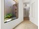 Hallway with view to bright courtyard showcasing lush greenery and desert landscaping at 19550 N Grayhawk Dr # 1117, Scottsdale, AZ 85255