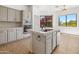 Modern kitchen with an island, stainless steel appliances, and bright natural light at 19550 N Grayhawk Dr # 1117, Scottsdale, AZ 85255