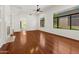 Bright living room with wood floors, neutral walls, a fireplace, and large windows at 19550 N Grayhawk Dr # 1117, Scottsdale, AZ 85255