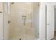 Shower featuring white subway tiles, frameless glass doors and showerhead at 19550 N Grayhawk Dr # 1117, Scottsdale, AZ 85255