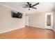 Spacious bedroom with hardwood floors, a ceiling fan, and a wall-mounted television at 20626 N 5Th Ave, Phoenix, AZ 85027