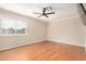 Bright bedroom featuring hardwood floors, a ceiling fan, and a large window at 20626 N 5Th Ave, Phoenix, AZ 85027