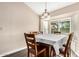 Bright dining room with large window, wood table, and a contemporary chandelier at 20626 N 5Th Ave, Phoenix, AZ 85027