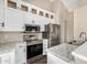 Modern kitchen featuring stainless steel appliances, granite countertops, and white cabinetry at 20626 N 5Th Ave, Phoenix, AZ 85027