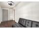 Cozy living room showcasing a modern fan, closet, and comfortable black sofa at 20626 N 5Th Ave, Phoenix, AZ 85027