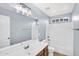 Bright bathroom with a large mirror, white vanity, and a shower-tub combination at 21031 E Creekside Dr, Queen Creek, AZ 85142