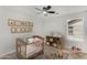 Charming Bedroom with a crib, neutral walls, and decorative animal artwork at 21031 E Creekside Dr, Queen Creek, AZ 85142