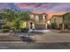 Charming two-story home with a well-maintained front yard and a spacious two-car garage at 21031 E Creekside Dr, Queen Creek, AZ 85142