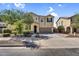 Charming two-story home with desert landscaping, a spacious driveway, and a two-car garage at 21031 E Creekside Dr, Queen Creek, AZ 85142