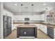 Contemporary kitchen featuring stainless steel appliances, granite countertops, and a functional center island at 21031 E Creekside Dr, Queen Creek, AZ 85142
