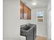 Well-equipped laundry room with modern washer and dryer units and storage cabinets at 21031 E Creekside Dr, Queen Creek, AZ 85142