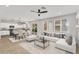 Bright and airy living room with modern furnishings and seamless flow to the kitchen and dining area at 21031 E Creekside Dr, Queen Creek, AZ 85142