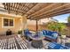 Relaxing outdoor living space with a cozy seating area and ample shade at 21031 E Creekside Dr, Queen Creek, AZ 85142