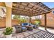 Stylish outdoor patio with comfortable seating and a shaded pergola at 21031 E Creekside Dr, Queen Creek, AZ 85142