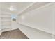 Spacious walk-in closet with shelves and clothing rods, maximizing organization at 21031 E Creekside Dr, Queen Creek, AZ 85142