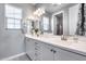 Bright bathroom featuring a dual sink vanity, white cabinets, and modern fixtures at 214 W Beverly Ln, Phoenix, AZ 85023