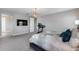 Spacious bedroom with a comfortable bed, carpeted floors, and a nearby treadmill at 214 W Beverly Ln, Phoenix, AZ 85023