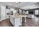 Spacious kitchen with island and bar stools overlooks the adjacent living area at 214 W Beverly Ln, Phoenix, AZ 85023