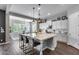 Kitchen features a central island with bar seating, white cabinets and stainless appliances at 214 W Beverly Ln, Phoenix, AZ 85023